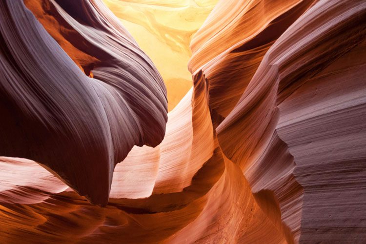 Antelope Canyon in Arizona showcases stunning slot canyons with wave-like structures and vibrant colors, a must-see for photography enthusiasts. Antelope Canyon is a photographer’s dream Arizona's best travel destinations