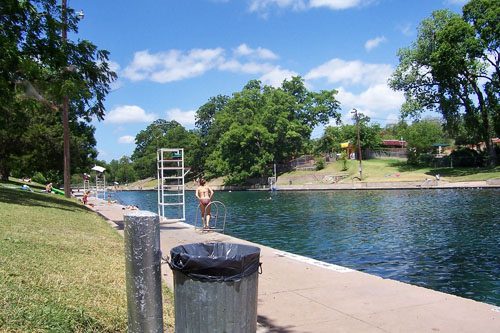 Swim in Barton Springs Pool, Austin's natural spring-fed oasis, perfect for a refreshing dip and year-round relaxation. Barton Springs Pool-min