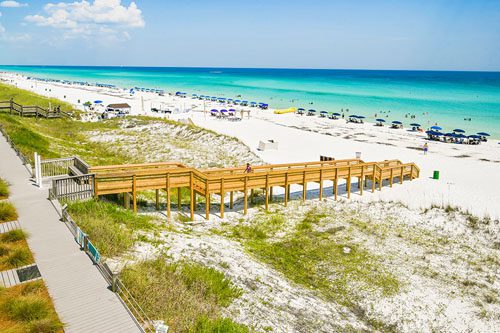 Relax on Crystal Sands Beach, known for its soft white sand and clear waters, offering the perfect backdrop for sunbathing, swimming, and beach activities. Things to do in Destin Florida with kids Crystal Sands Beach