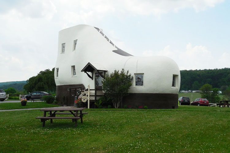 Top Places to See in Pennsylvania A whimsical view of Haines Shoe House, a quirky shoe-shaped house surrounded by lush greenery, offering a fun and unique roadside attraction.