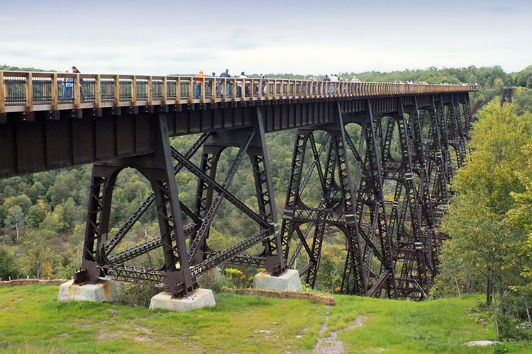 Pennsylvania’s Best Places to Explore A stunning view of the Kinzua Bridge Skywalk, featuring the dramatic remains of the bridge extending over a deep gorge.