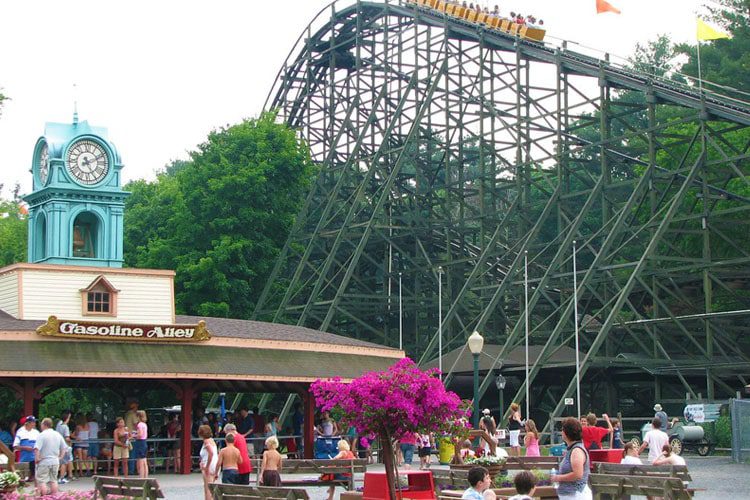 Best Sights to See in Pennsylvania A lively scene at Knoebels Amusement Park, showcasing colorful rides, and families enjoying the classic amusement park