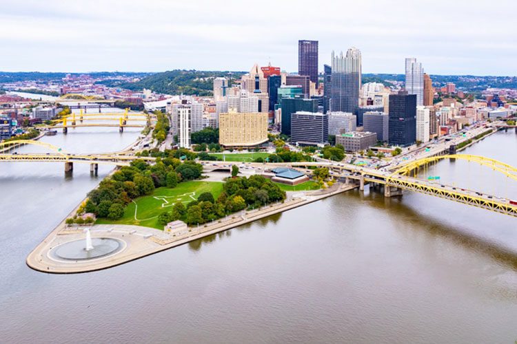 Best Places to Visit in Pennsylvania Stunning skyline of Pittsburgh, Pennsylvania, with its iconic rivers and bridges, framed by vibrant city lights. A bustling metropolis